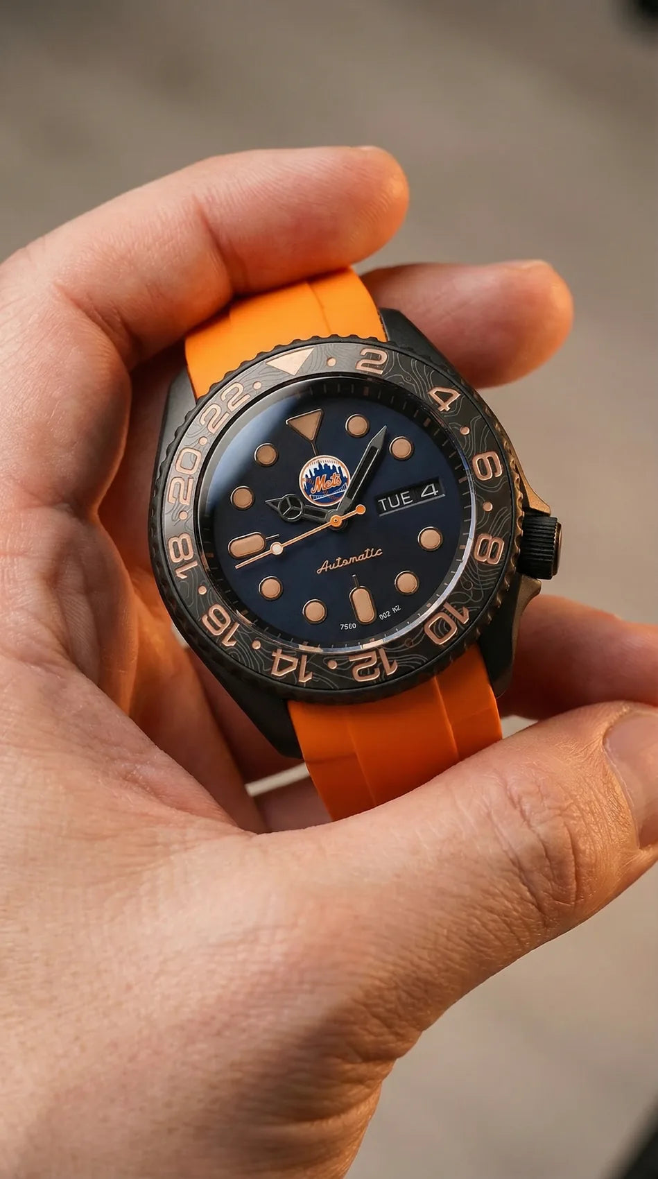 Client custom watch with an orange strap and gold details